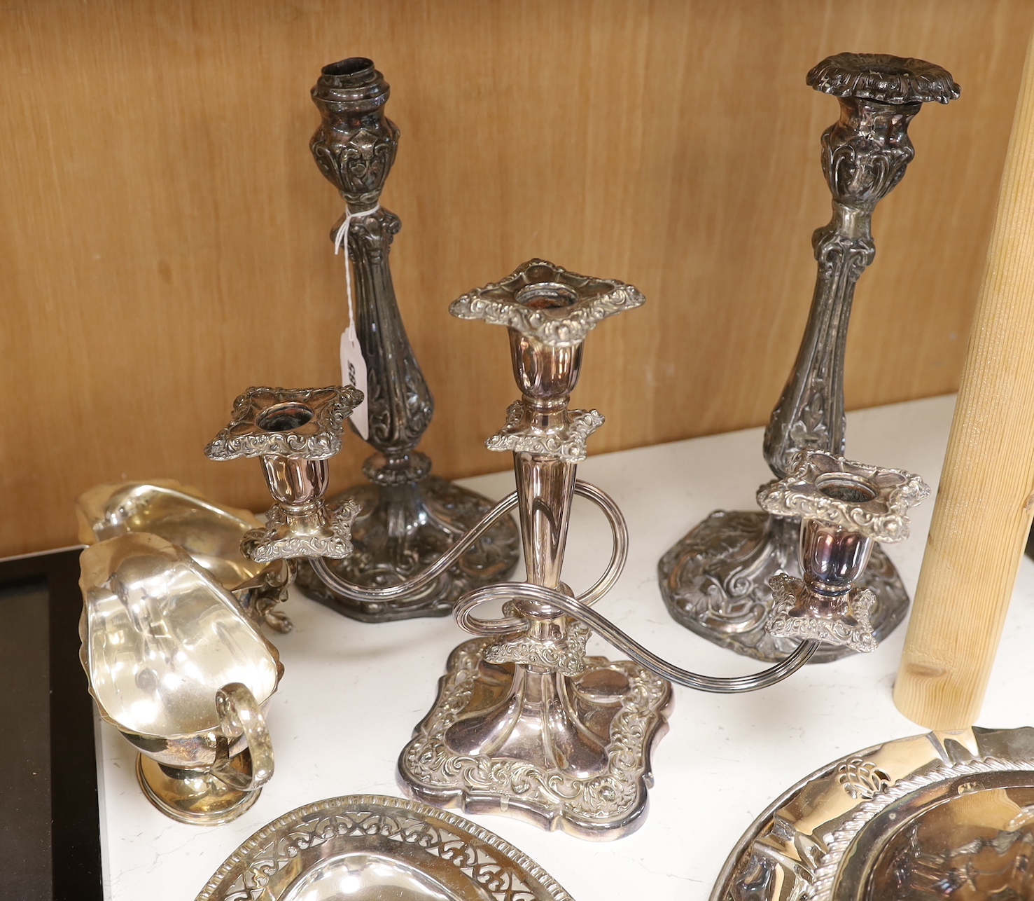 A selection of assorted plated ware, to include a pair of candlesticks, a pair of sauceboats, etc. tallest 28.5cm